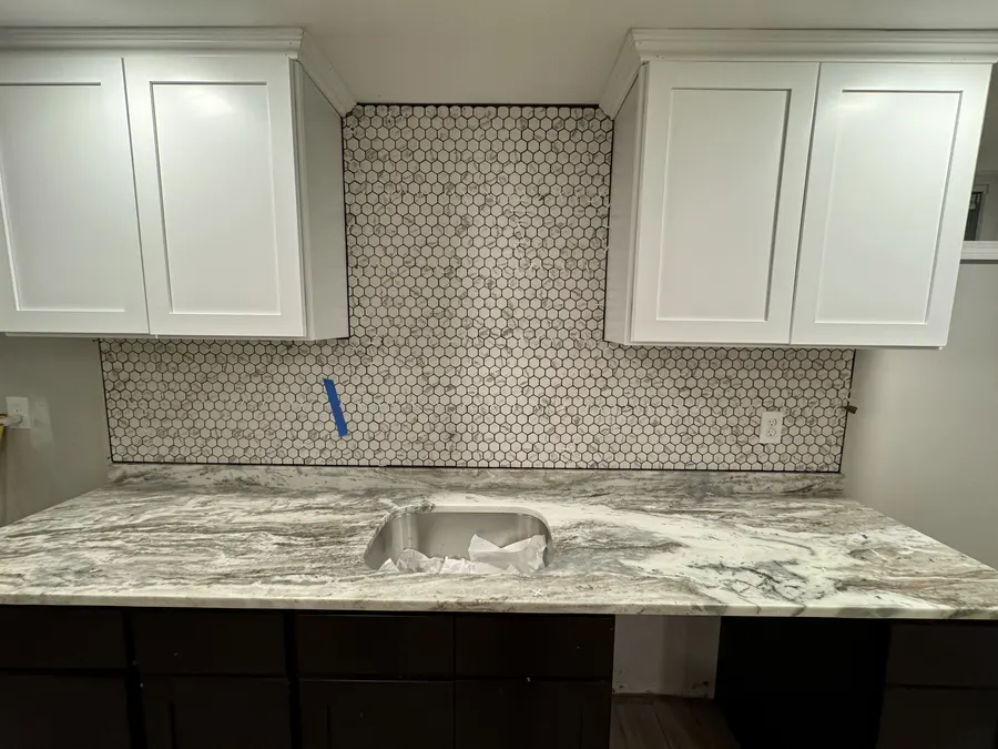 Kitchen with mosaic backsplash and stone counter