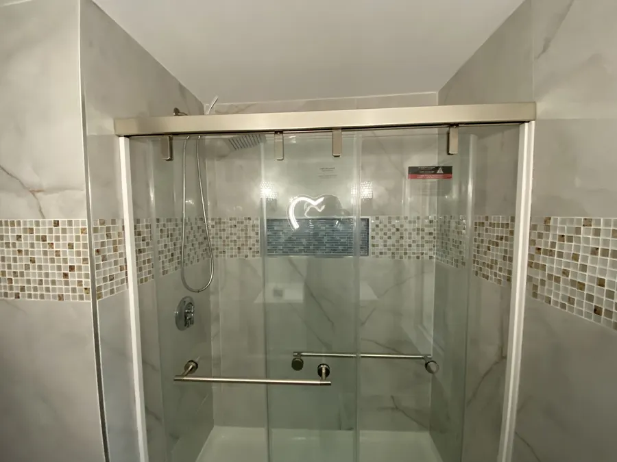 Tiled shower with glass sliding doors