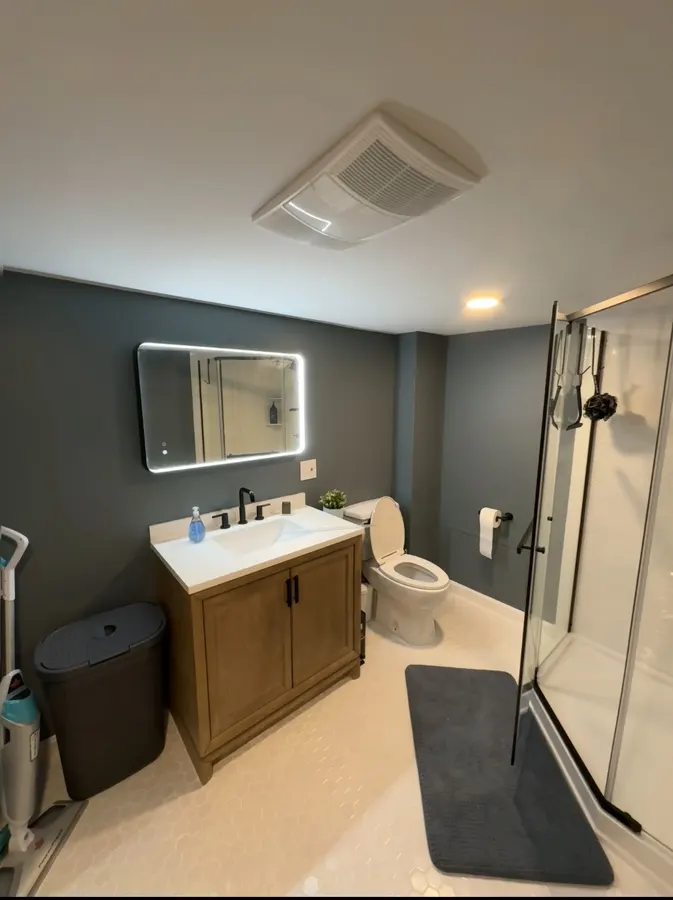 Bathroom with wood vanity and glass shower