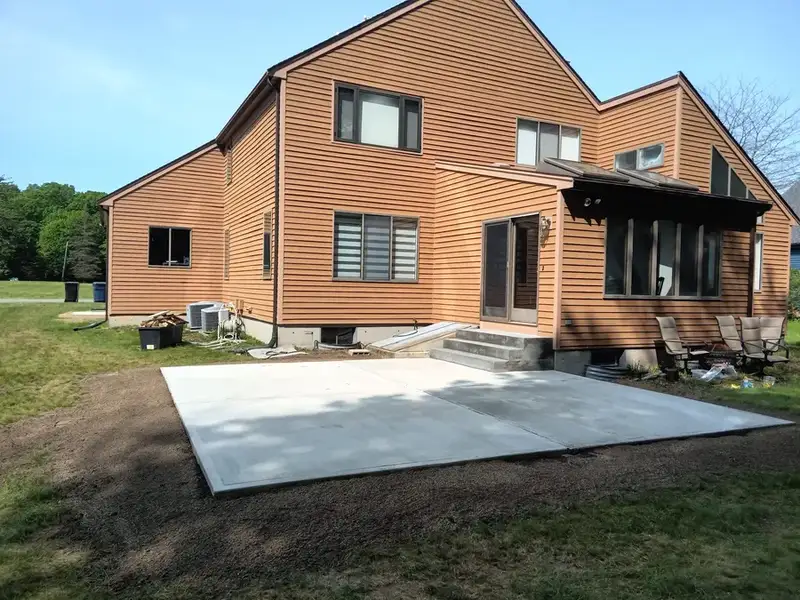 Brick house with a new concrete patio pad